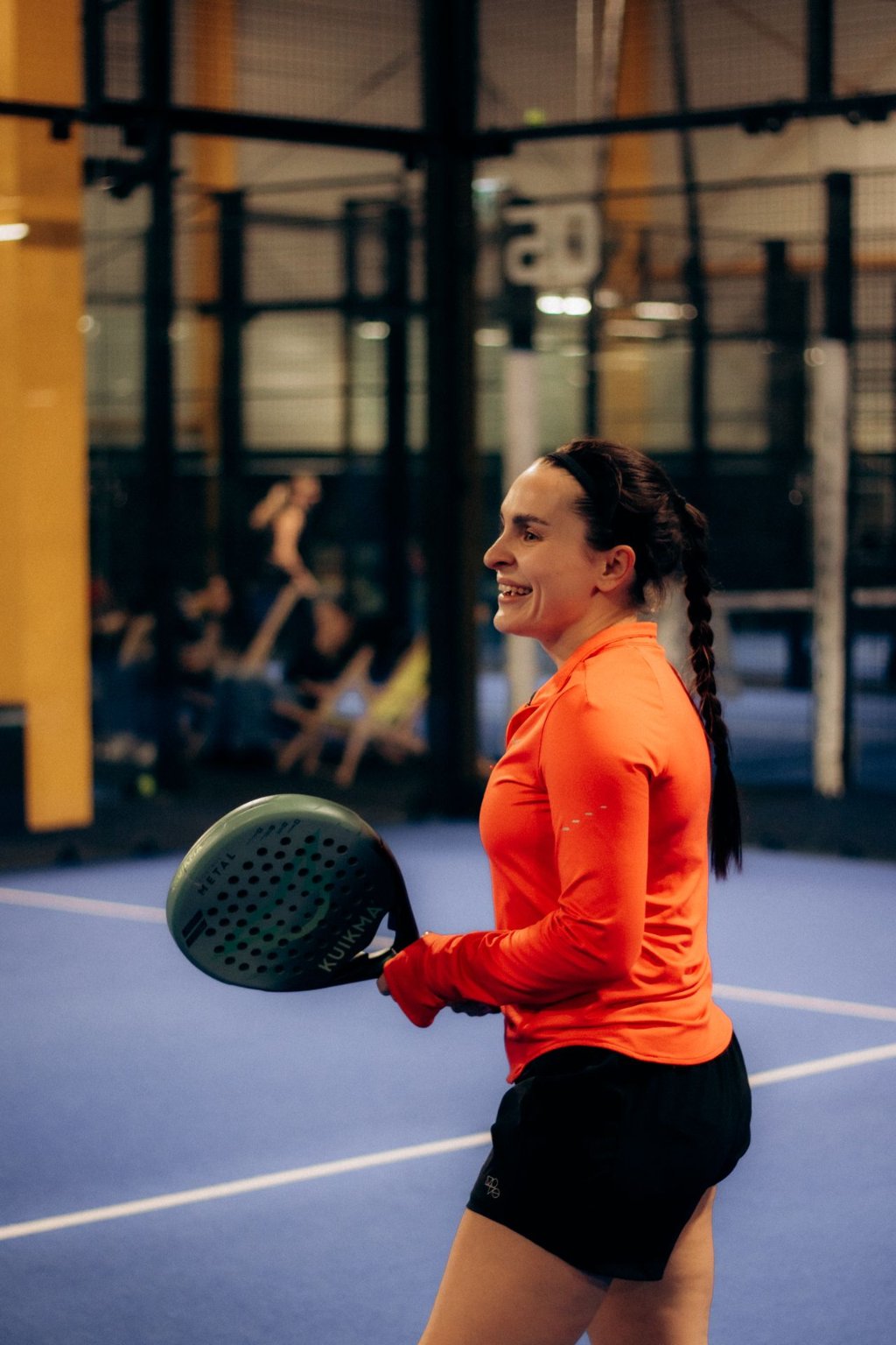 Players enjoying a game on an indoor padel court